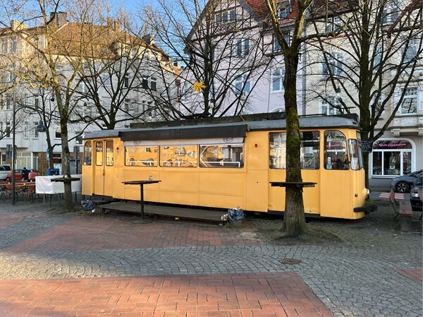 Blick auf eine schöne, alte, eierschalenfarbene Tram.
